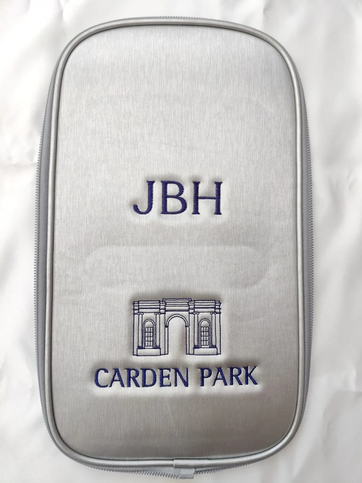 Silver golf accessory bag monogrammed 'JBH' with the Carden Park golf club crest