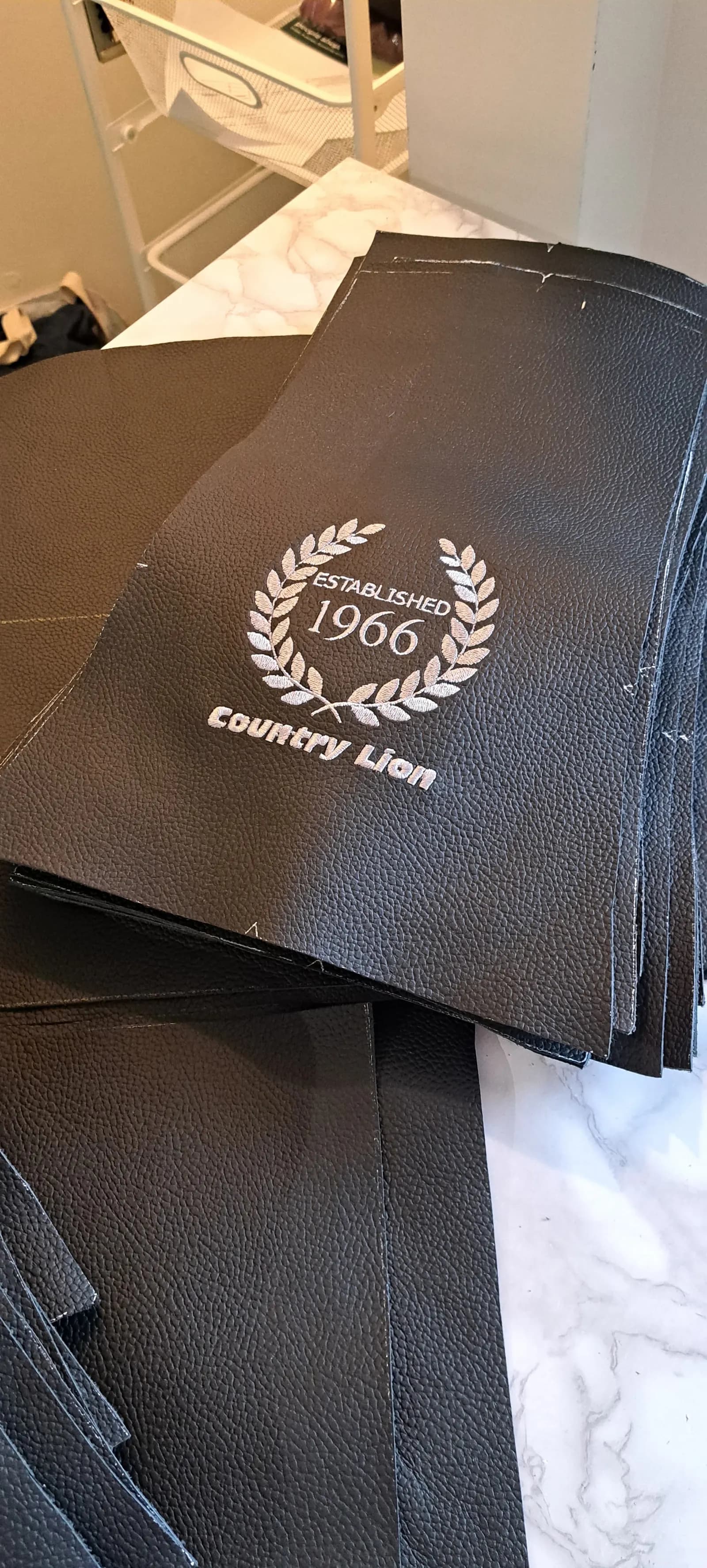 Black leather headrest panels embroidered with the Country Lion 'Established 1966' laurel crest