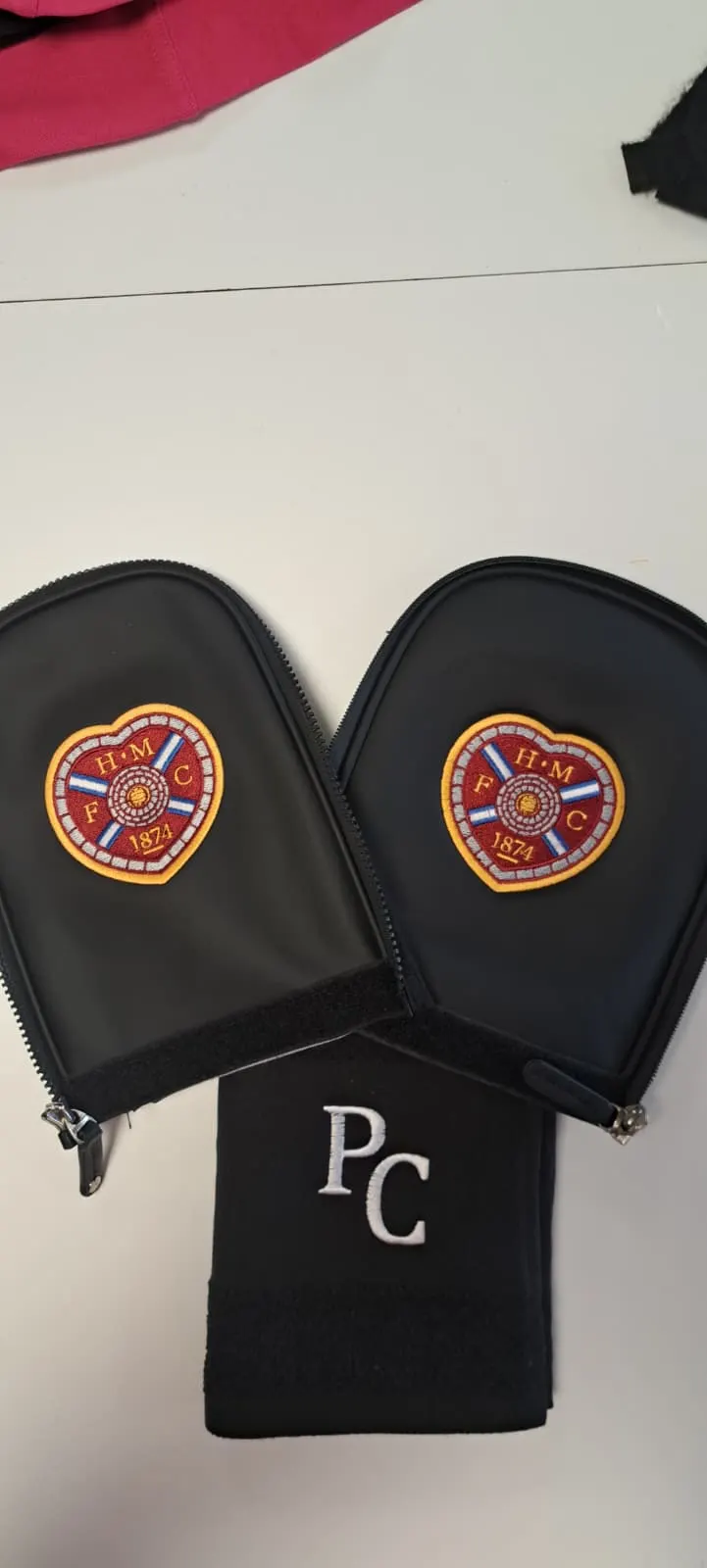 Golf club head covers embroidered with the Heart of Midlothian FC crest, alongside a personalised 'PC' golf sock