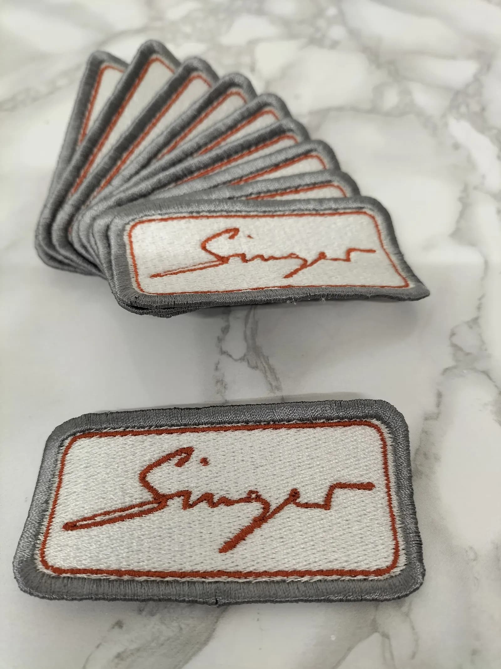 Embroidered Singer badge stitched on the machine