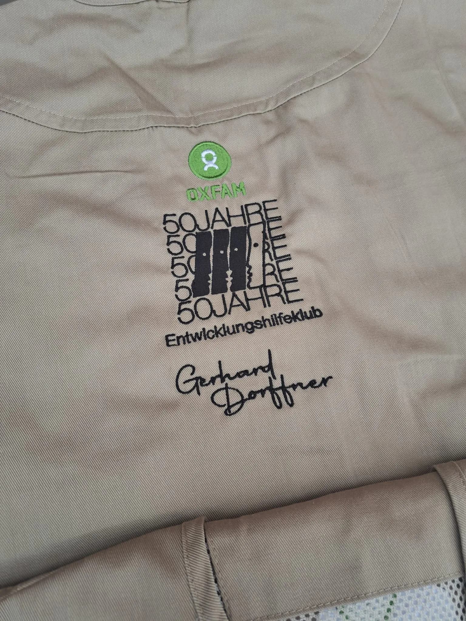 Oxfam charity embroidery on a shirt