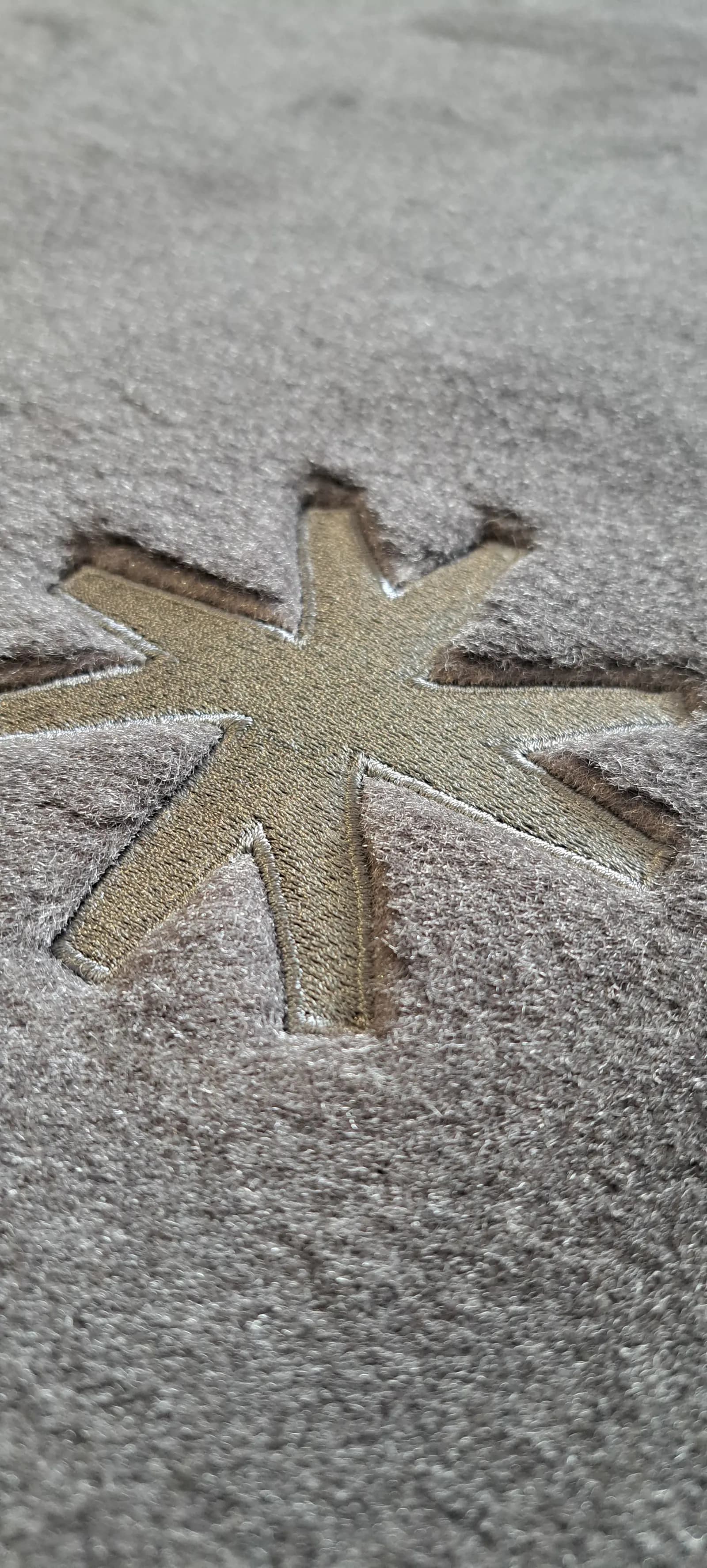 Aircraft carpet with a star-shaped Propel logo embroidered into the pile