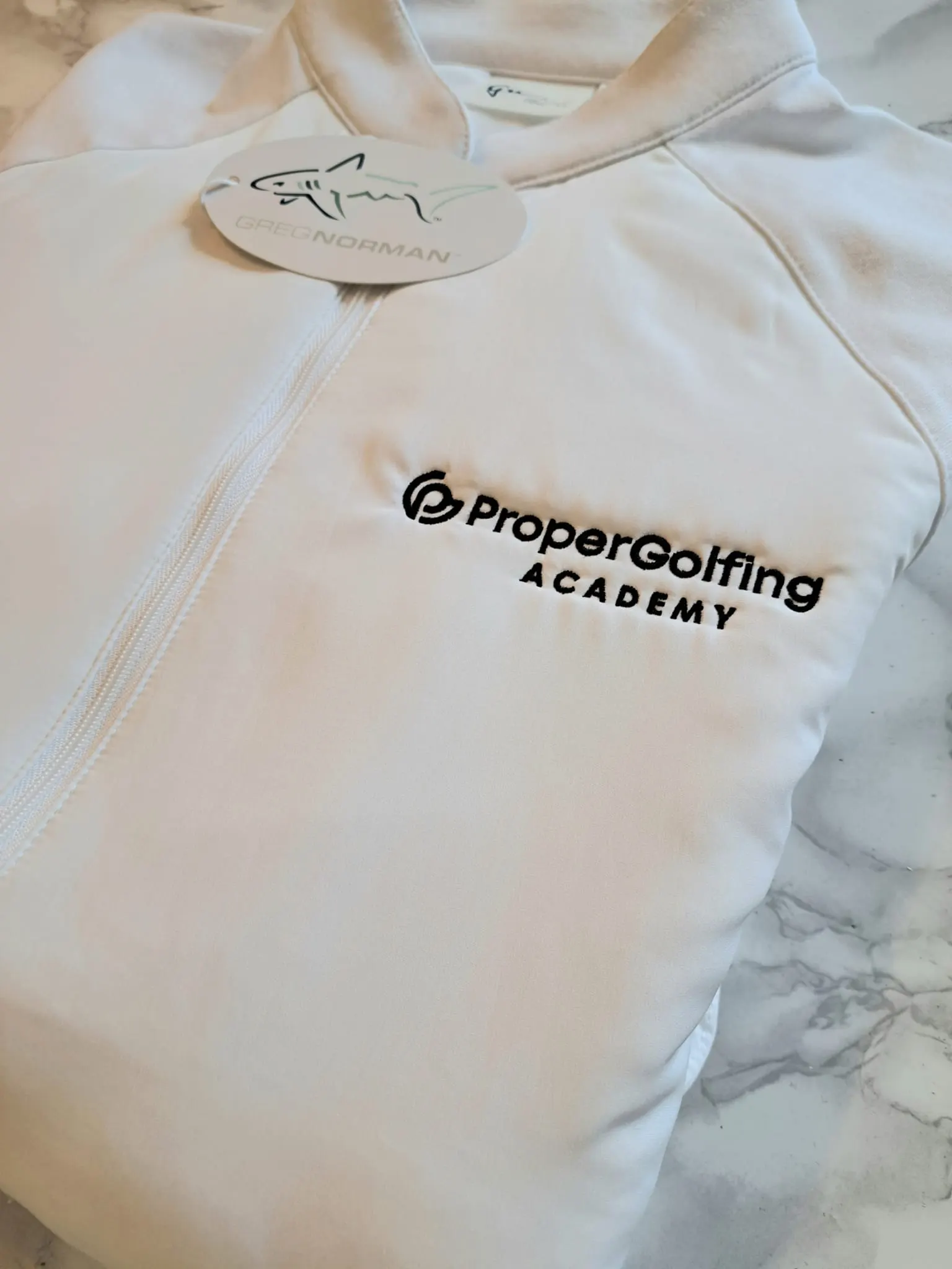 Greg Norman golf jacket embroidered with the ProperGolfing Academy logo