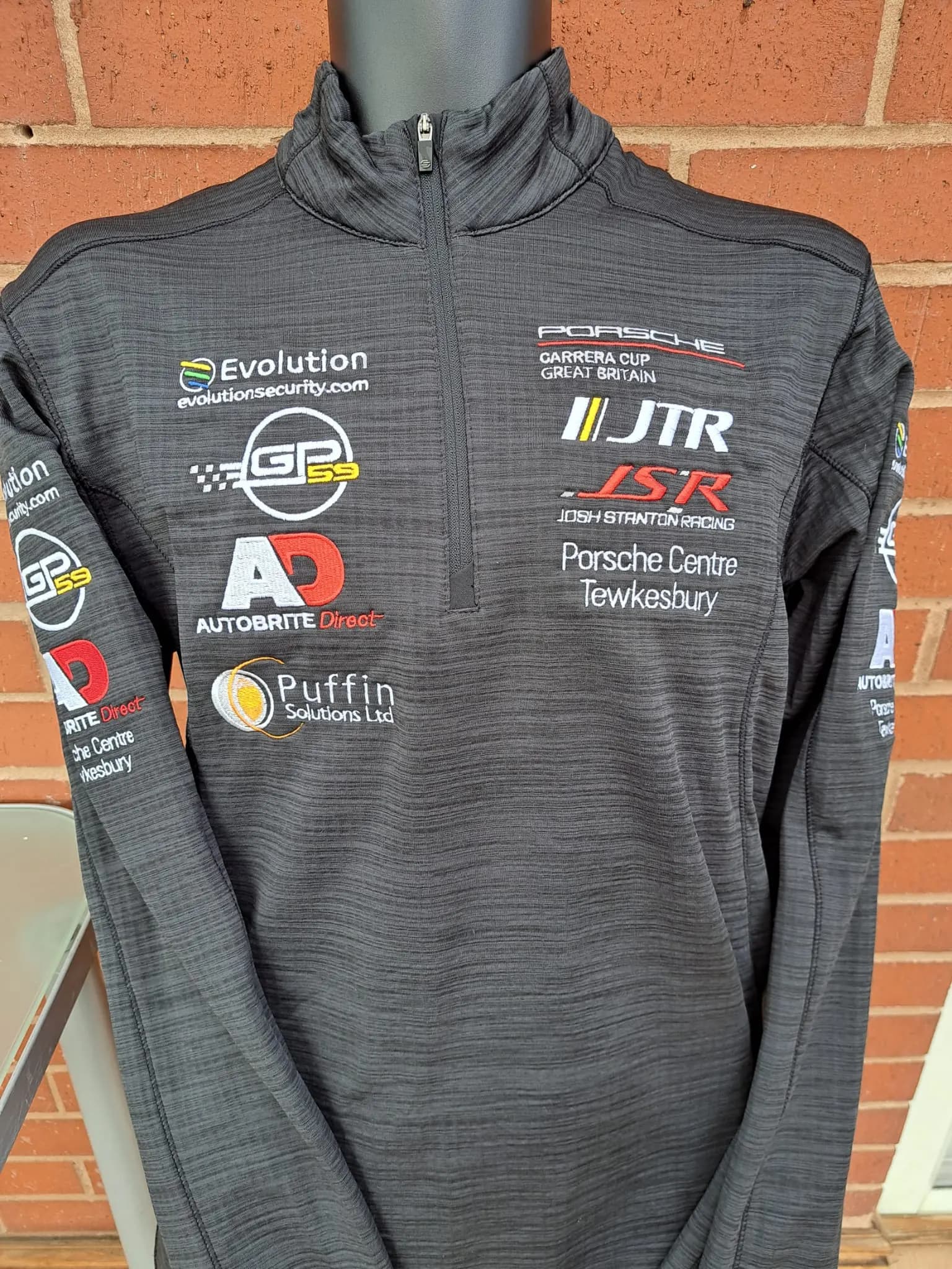 Motorsport quarter-zip shirt embroidered with multiple sponsor logos for a Porsche Carrera Cup GB team