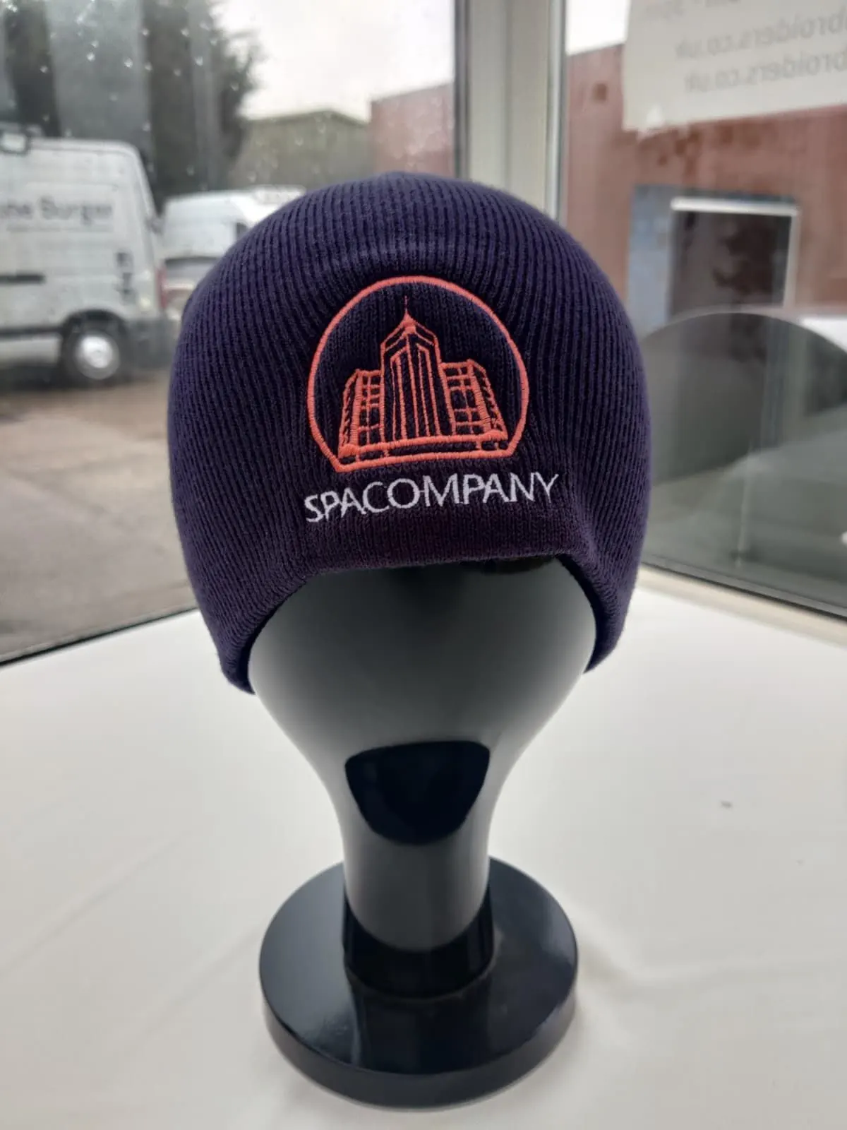 SpaCompany commercial cleaning logo on a work beanie