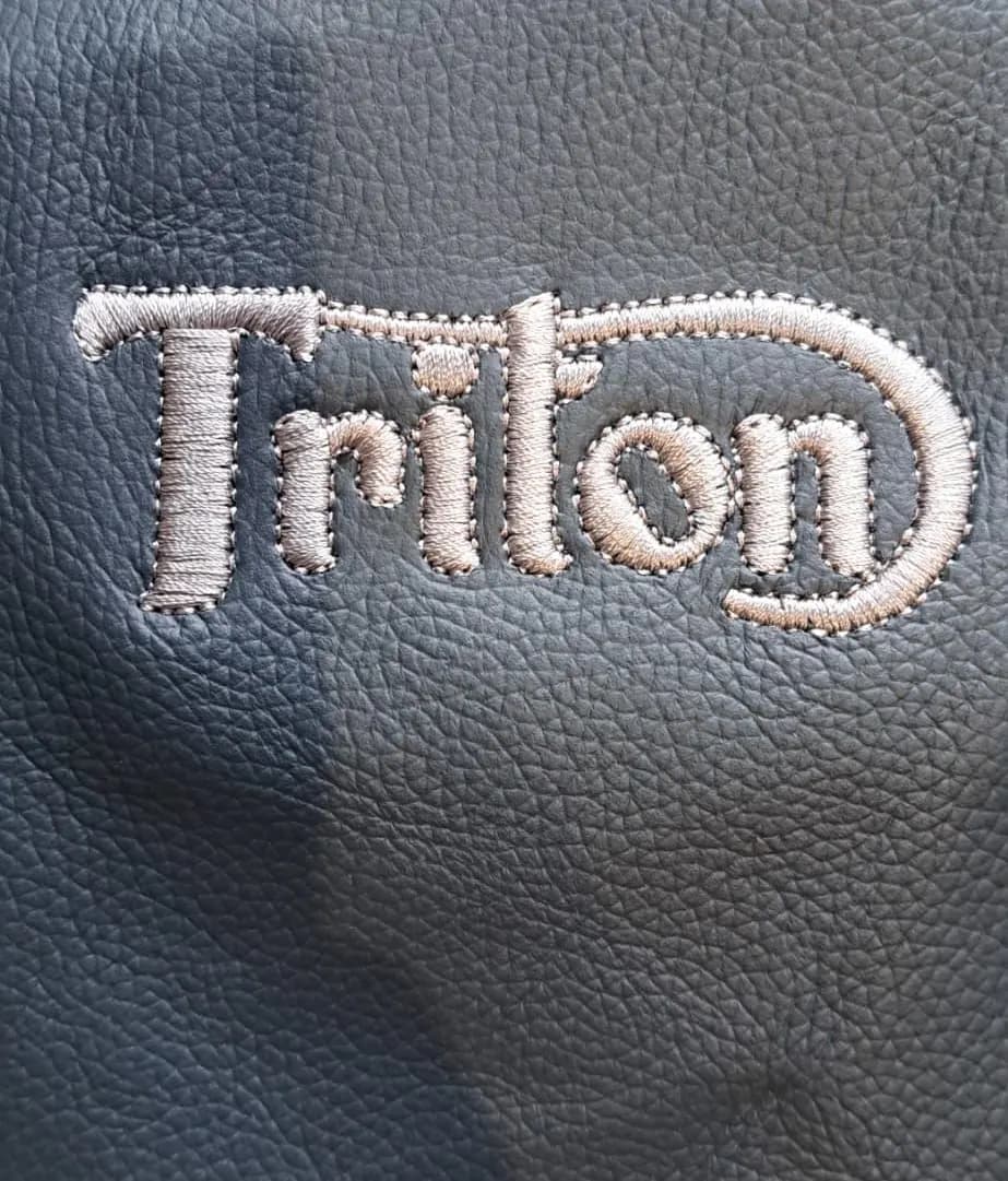 Embroidered leather seat panel for an Italian moped